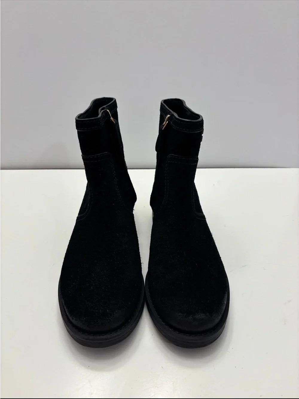 Tory Burch black suede Eloise flat booties with a prominent gold-tone metal logo